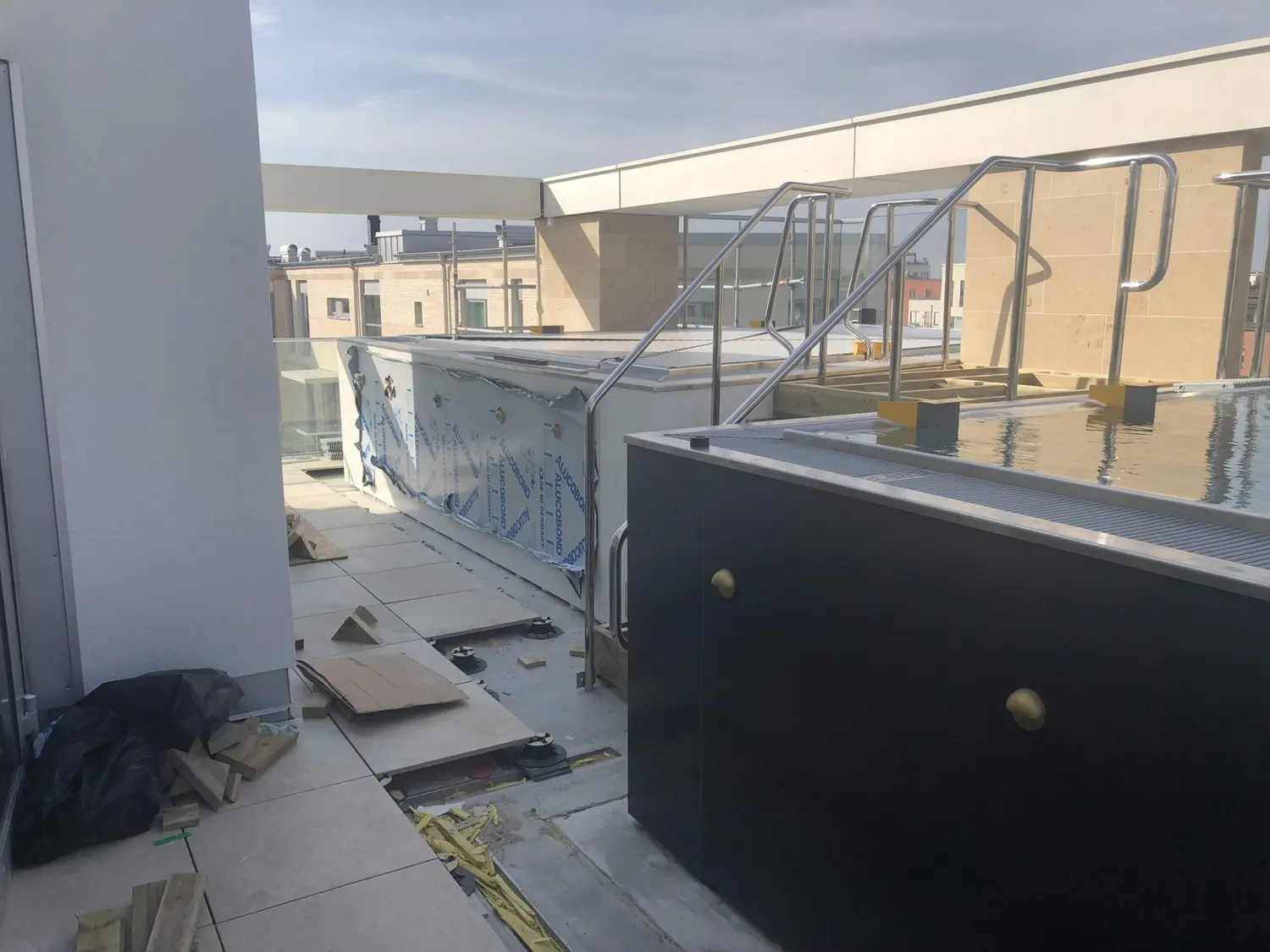 Terrassen med poolens plåtsidor och räcke i rostfritt. Bild 6 av 18